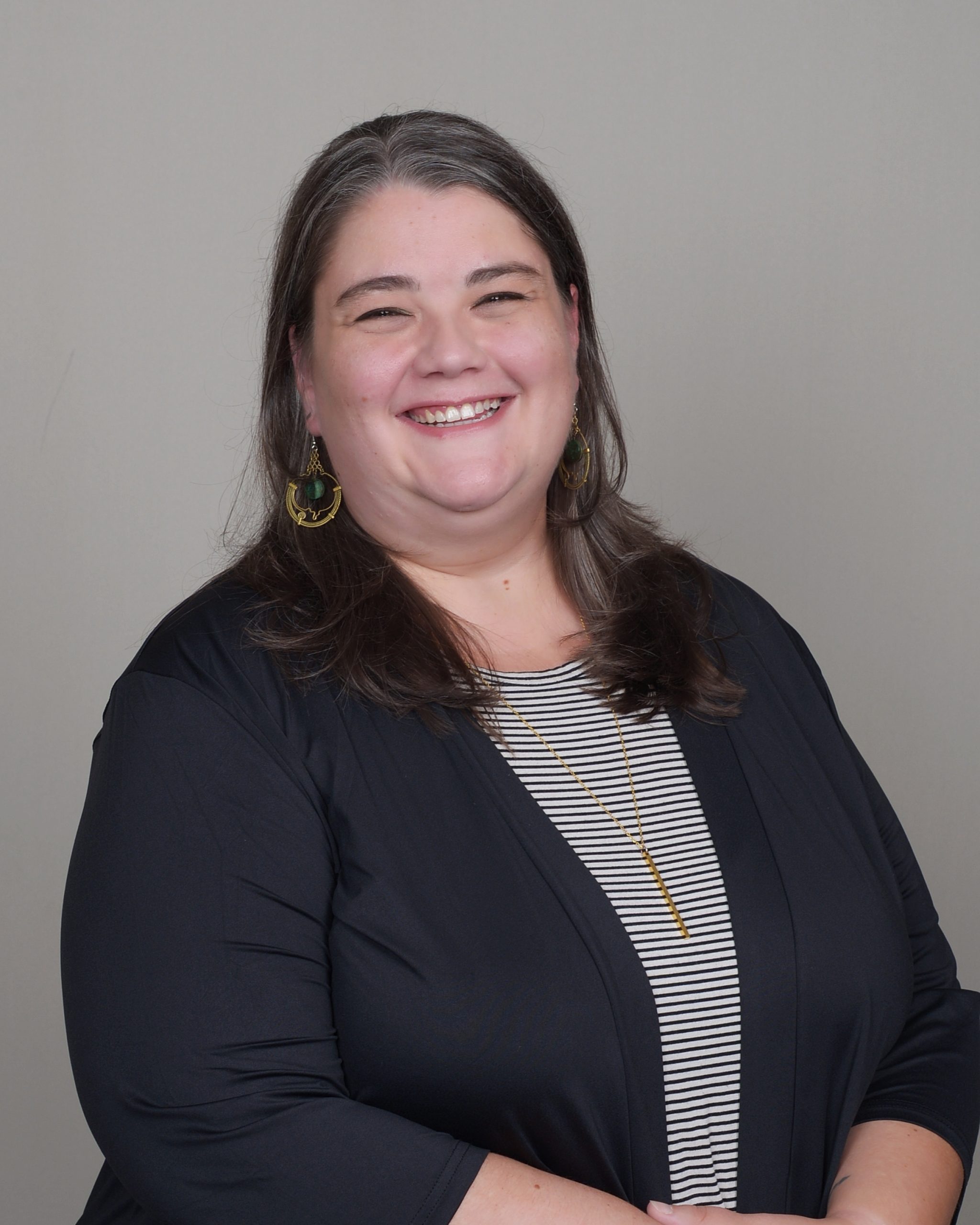 Close up portrait happy smiling young woman with hands in curly hair and looking up